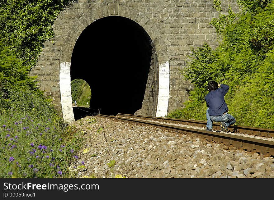 While a villager walking at end of tunnel, photographer trying to frame her. While a villager walking at end of tunnel, photographer trying to frame her.