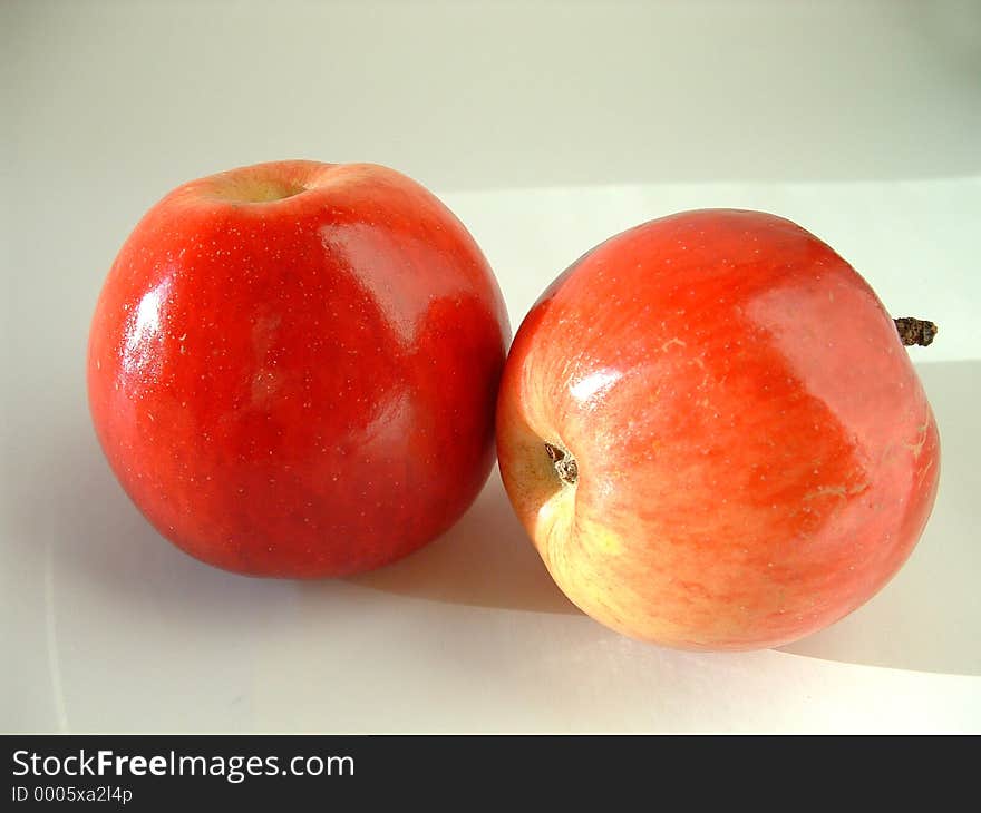 Red, shiny apples on light background. Red, shiny apples on light background.