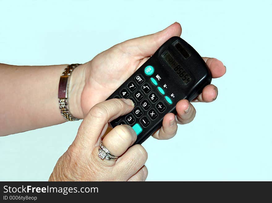 A lady using a hand held calculator. A lady using a hand held calculator.