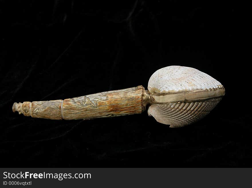 A decorative native style shaker made with antler, wood, and seashell. Has engraved handle. A decorative native style shaker made with antler, wood, and seashell. Has engraved handle