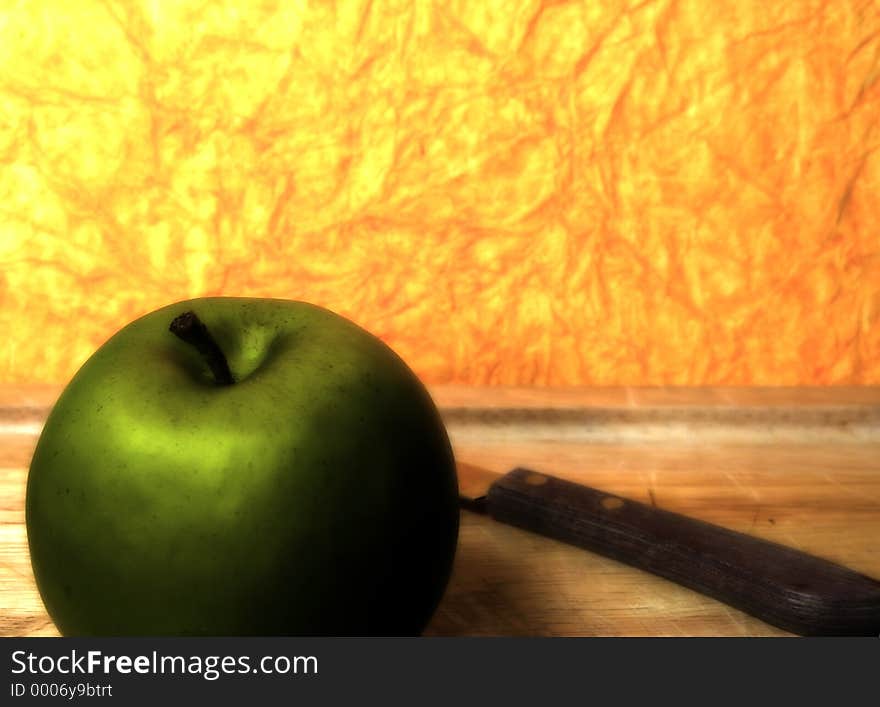 Photo of a Green Apple With Orange Background With Blur and Color Effect.