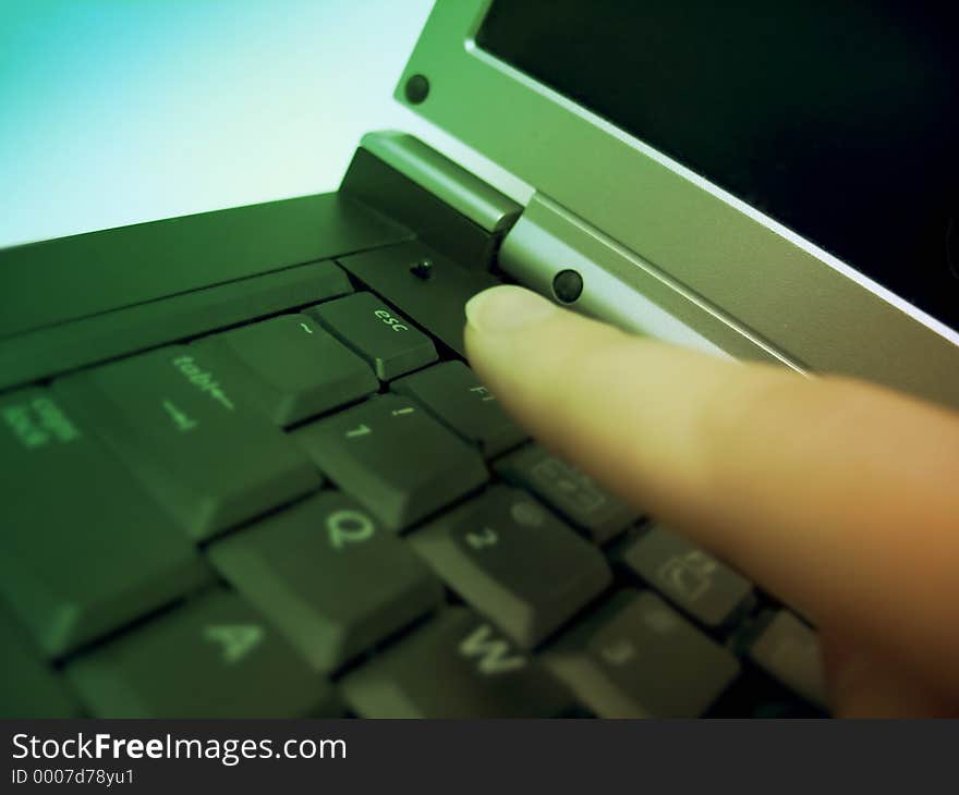 Finger about to press the escape key on a laptop. Focus on the esc. key. Finger about to press the escape key on a laptop. Focus on the esc. key.