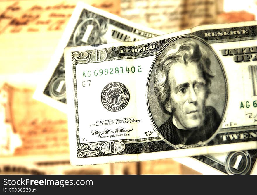 Photo of a Twenty and a Dollar With Old Docuemtns in Background. Blur and Color Effect. Photo of a Twenty and a Dollar With Old Docuemtns in Background. Blur and Color Effect.