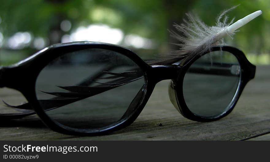 Eye glasses and feather. An image which can be on a cover page of a biographic novel...it's only an idea. Eye glasses and feather. An image which can be on a cover page of a biographic novel...it's only an idea...