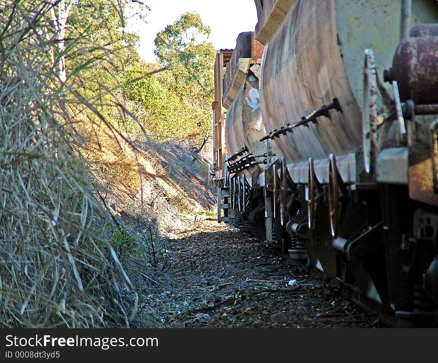 Railway rolling stock going through a cutting in Queensland, Australia.