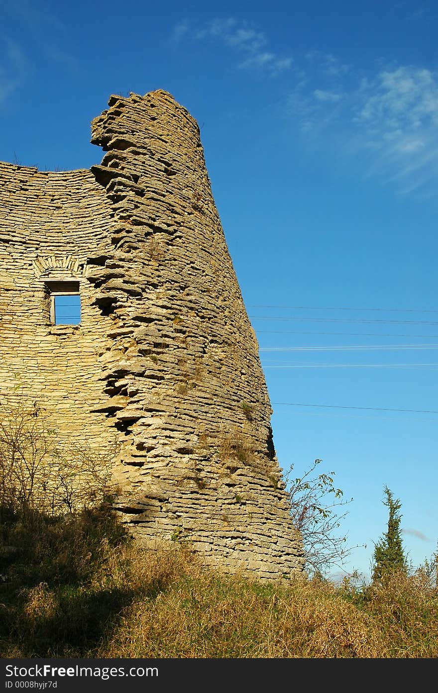 Ruins of an old windmill at sunset and on clear sky backdrop. Ruins of an old windmill at sunset and on clear sky backdrop.