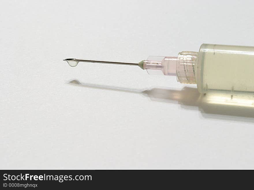 A hypodermic needle with a droplet of flid. A hypodermic needle with a droplet of flid.