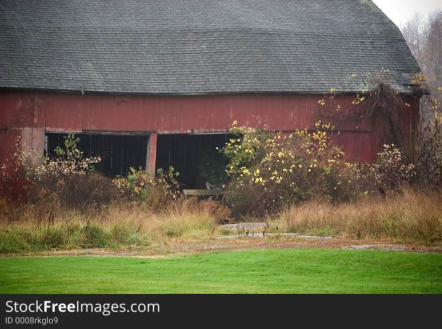 A red barn photographed throught the mist of a light rain. A red barn photographed throught the mist of a light rain