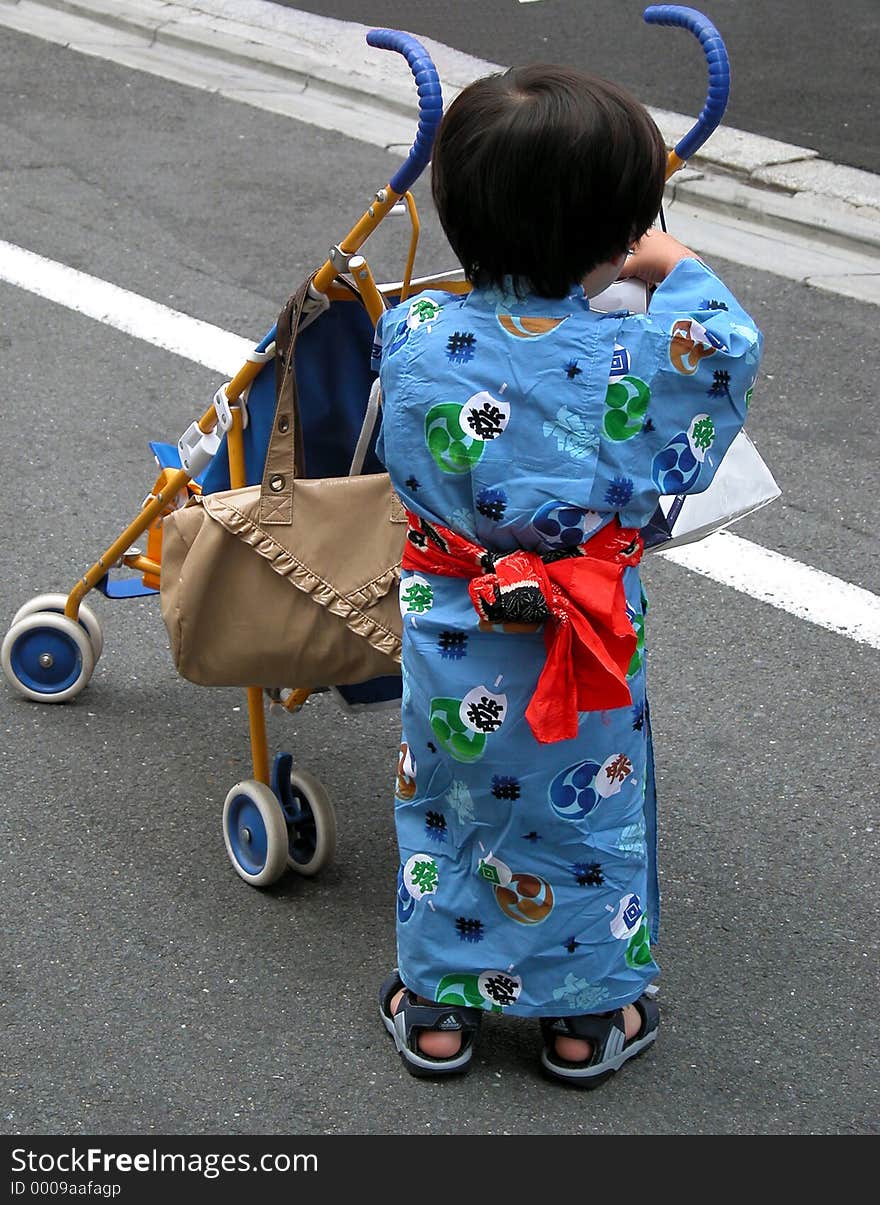 A Japanese boy wearing a specific Kimono during the Gion Matsuri the biggest street festival in Kyoto,Japan. A Japanese boy wearing a specific Kimono during the Gion Matsuri the biggest street festival in Kyoto,Japan