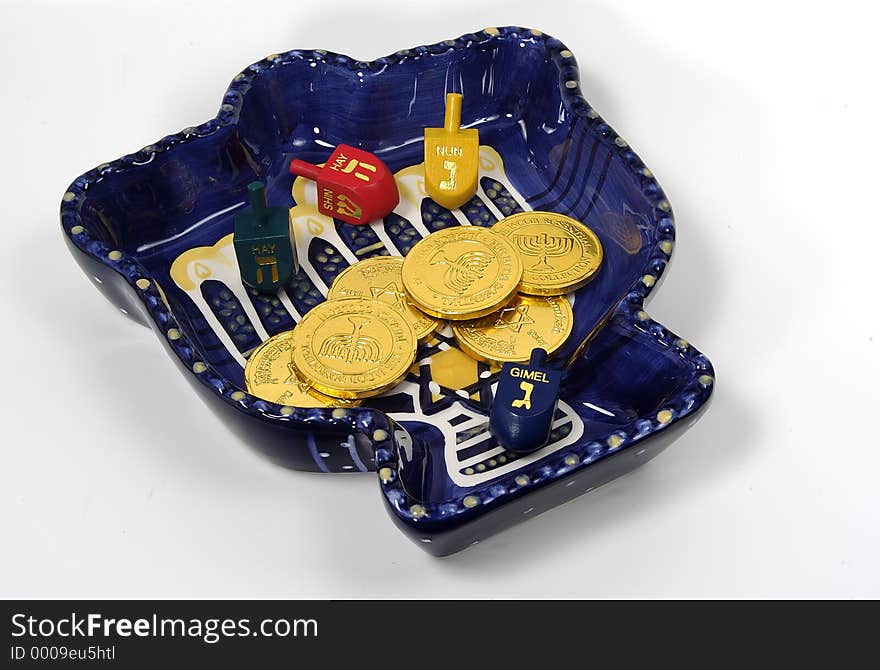 Photo of a Chanukah Bowl With Dreidels and Gelt. Photo of a Chanukah Bowl With Dreidels and Gelt.