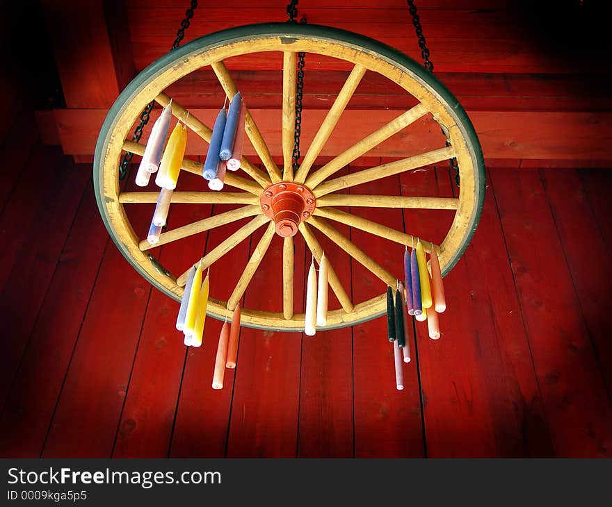 Candles hung to dry on wagon wheel