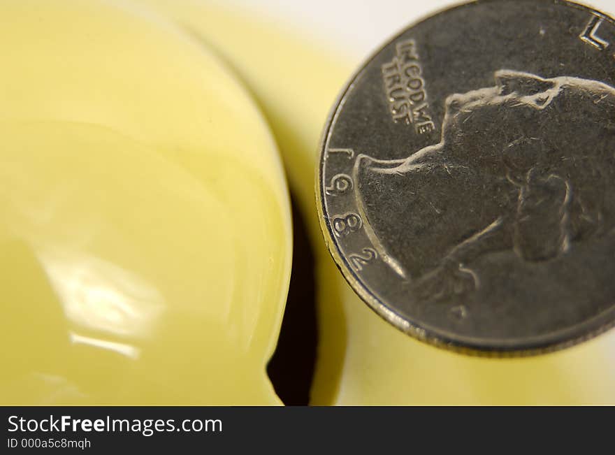 Photo of a Quarter Being Inserted Into a Piggy Bank. Photo of a Quarter Being Inserted Into a Piggy Bank.