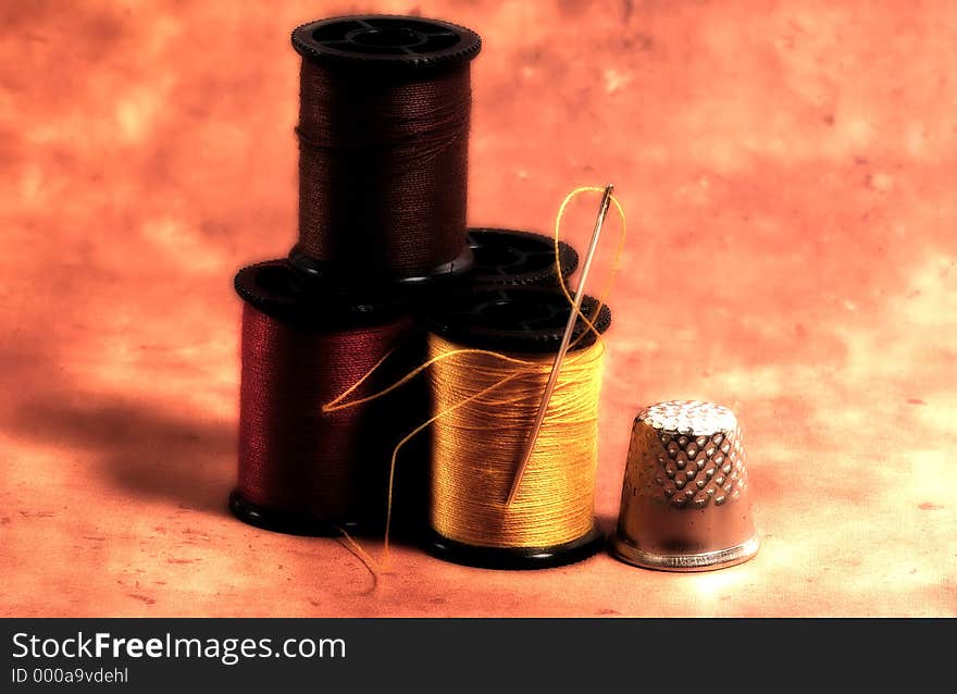 Photo of Needle and Thread Spools With Color and Blur Effect. Photo of Needle and Thread Spools With Color and Blur Effect.