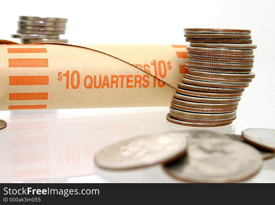 Stacks of coins and a money wrapper for US Quarters. Stacks of coins and a money wrapper for US Quarters.