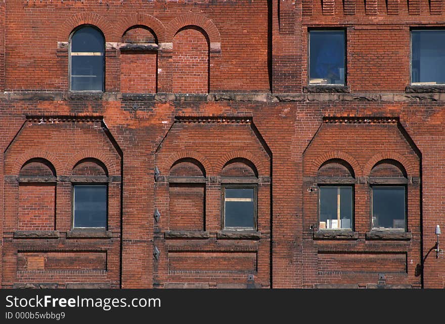 The exterior of a brick building with windows. The exterior of a brick building with windows.