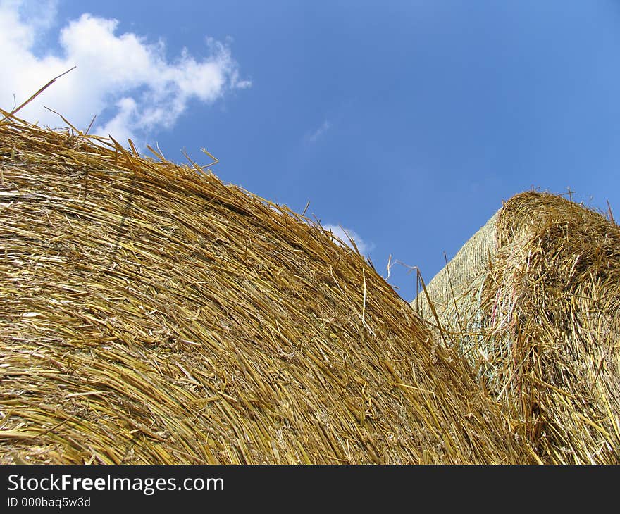 Hay bale roles in front of blue sky. Hay bale roles in front of blue sky.