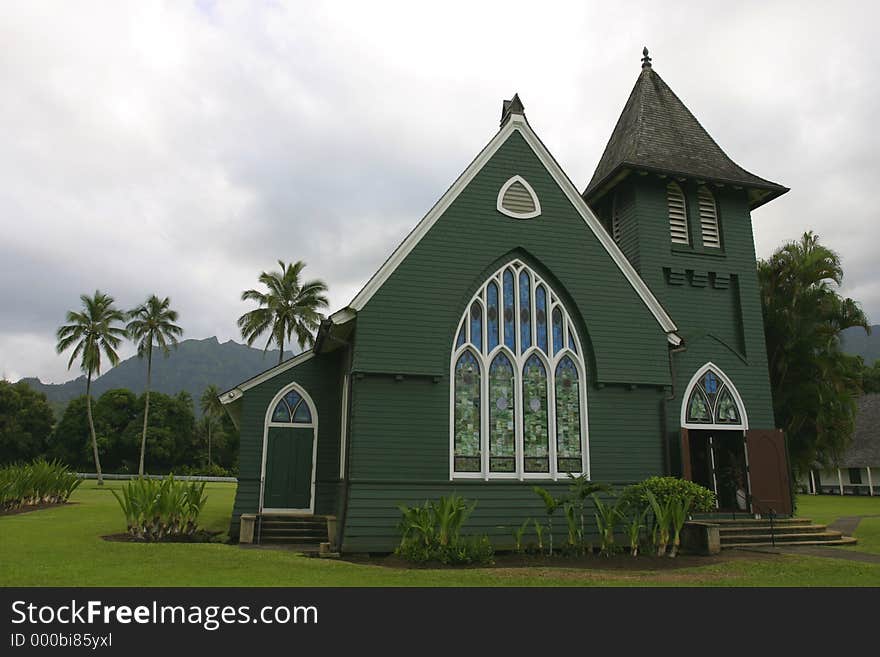 Small green church with mountain and palm trees in background. Small green church with mountain and palm trees in background