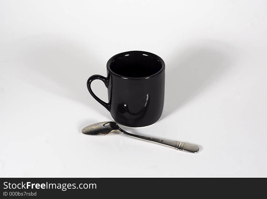 An espresso cup & spoon. An espresso cup & spoon
