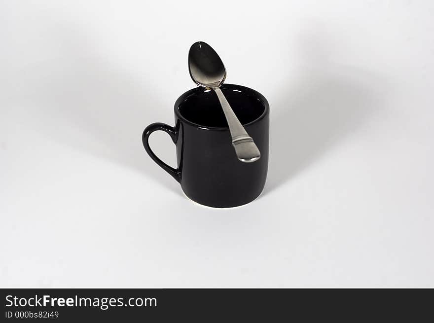 An espresso cup and it's little spoon on it. An espresso cup and it's little spoon on it.