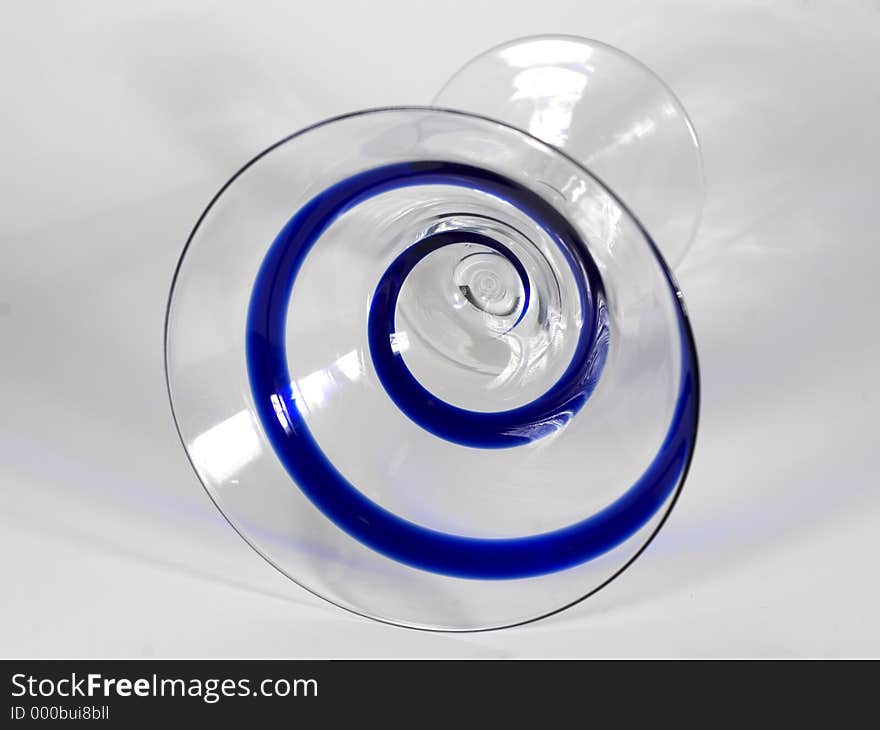 A frontal view of a martini glass with a blue swirl pattern, isolated. A frontal view of a martini glass with a blue swirl pattern, isolated