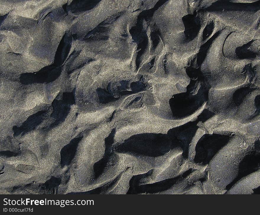 Wet sand in an interesting pattern of ripples and rivulets. Nice for backgrounds and textures. Wet sand in an interesting pattern of ripples and rivulets. Nice for backgrounds and textures.