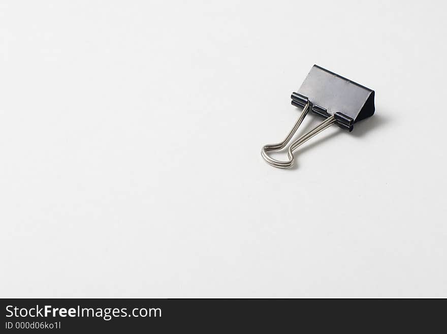 An isolated paper clip on white background. An isolated paper clip on white background