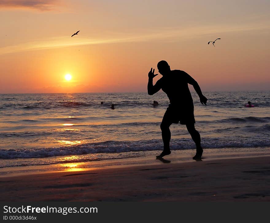 Man silhouette on the beach at sunset. Man silhouette on the beach at sunset