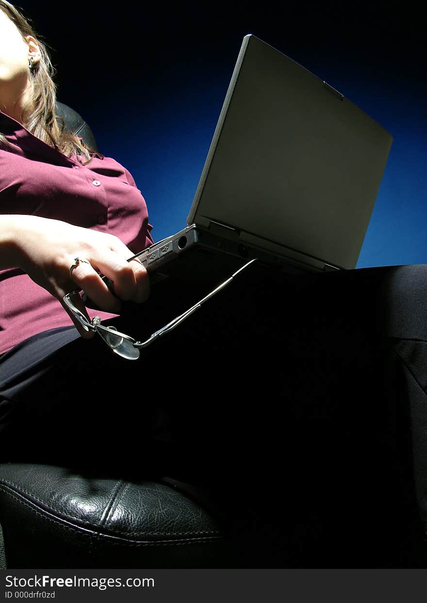 Woman using a laptop and talking with someone over the shoulder. Woman using a laptop and talking with someone over the shoulder.