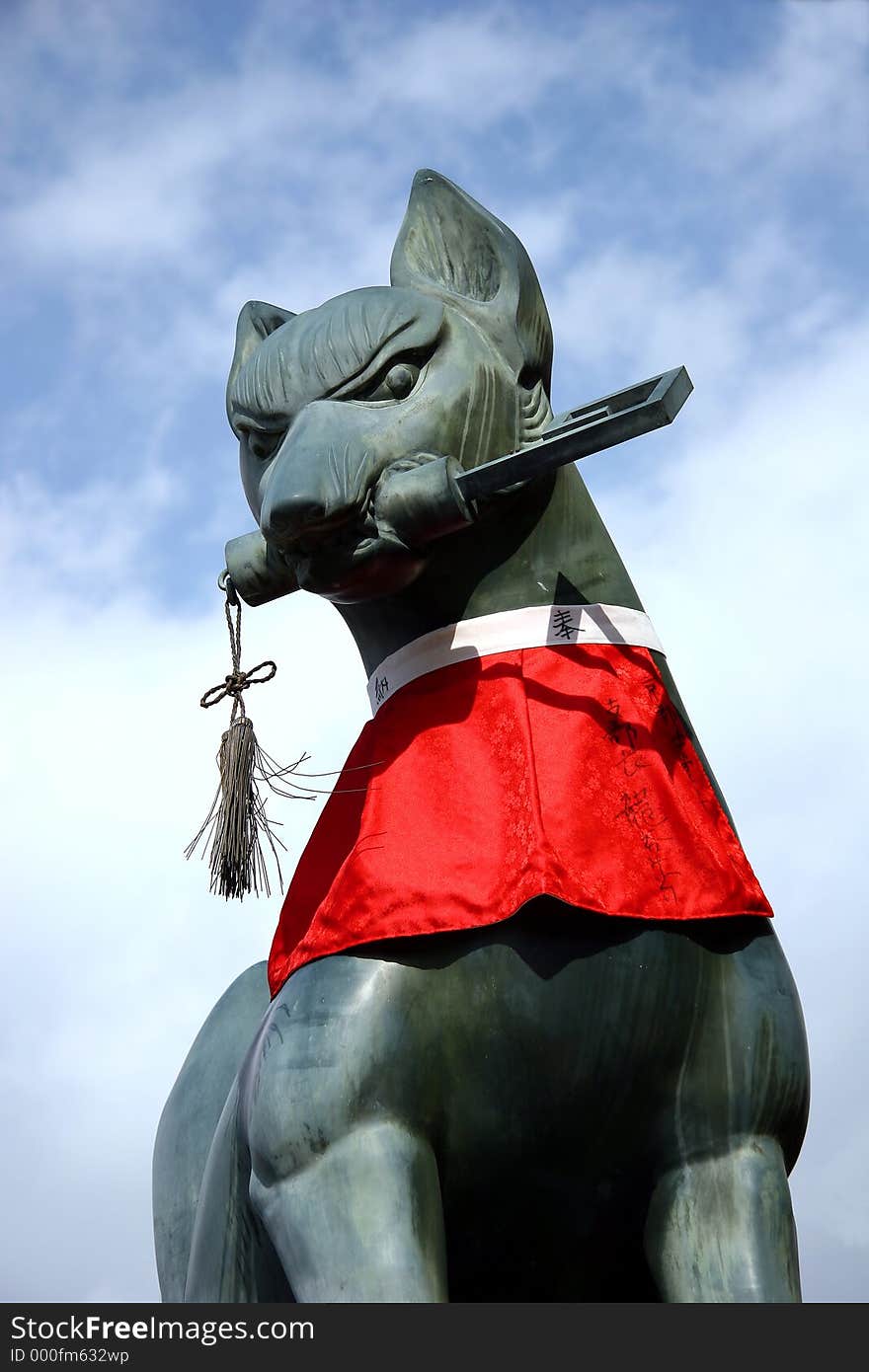 A cat that is part of group of stone iron objects guarding the gates to a temple in Kyoto, Japan. A cat that is part of group of stone iron objects guarding the gates to a temple in Kyoto, Japan.