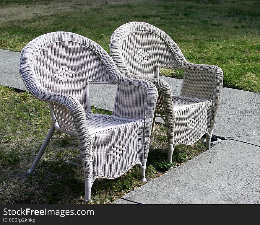 Two empty lawn chairs waiting for someone to occupy them