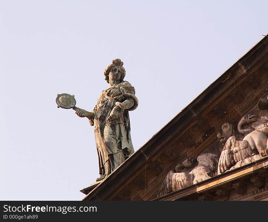 Statue on roof of royal palace, Dam square Amsterdam