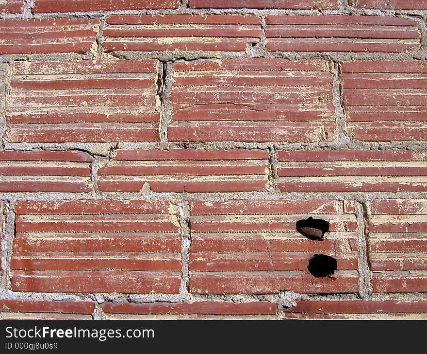 An old brick wall, with crumbling mortar and a couple of holes drilled into it. Useful for backgrounds and textures. An old brick wall, with crumbling mortar and a couple of holes drilled into it. Useful for backgrounds and textures.