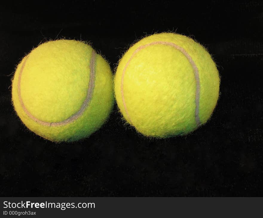 Two tennis balls on black background. Two tennis balls on black background