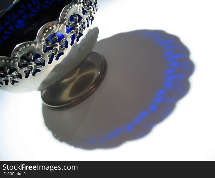 Silver and glass bowl making interesting colour in shadow. Silver and glass bowl making interesting colour in shadow