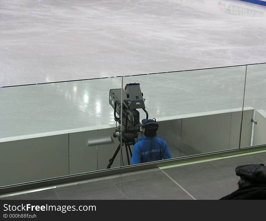 Cameraman taking a break when Zamboni is working. Cameraman taking a break when Zamboni is working