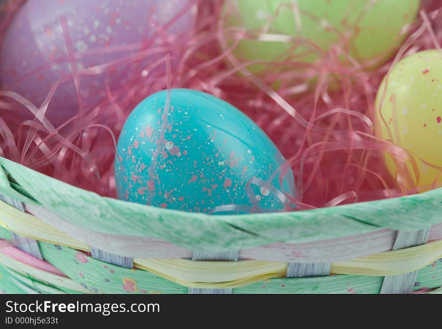 Pastel easter basket with plastic speckled eggs. Pastel easter basket with plastic speckled eggs
