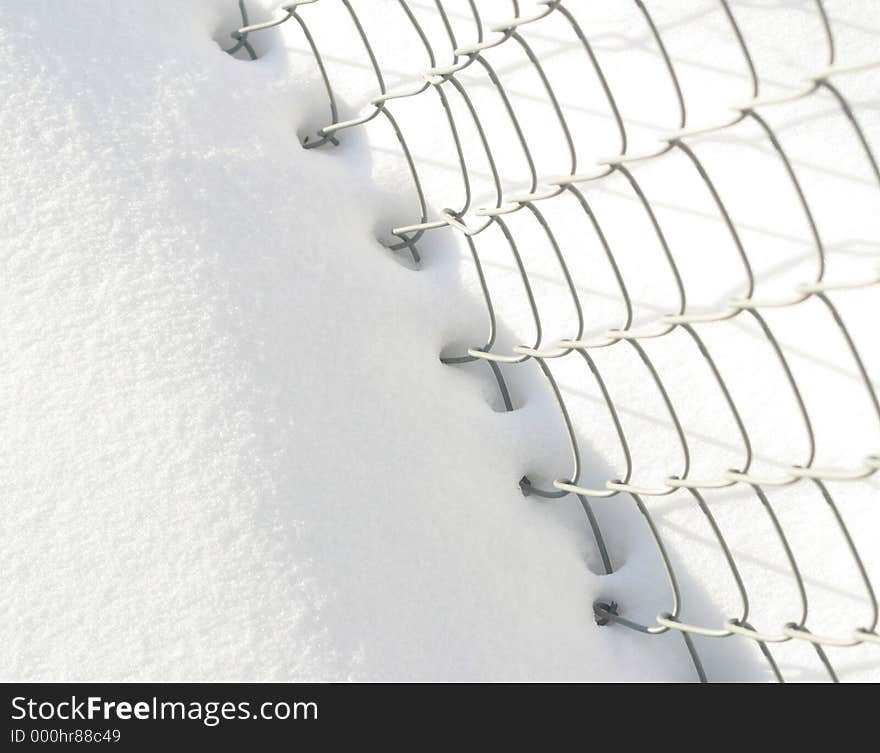 Snow and chain-link fence. Snow and chain-link fence.