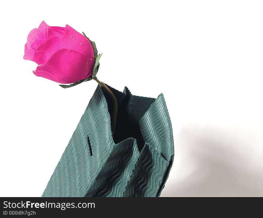 Green corrugated gift bag; hot pink rose. Green corrugated gift bag; hot pink rose