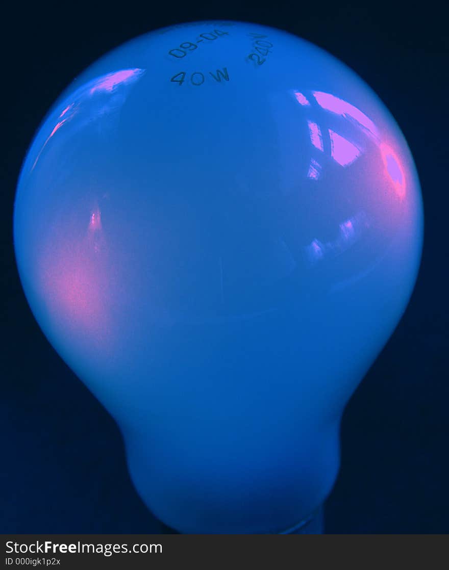 Blue light bulb against a black background