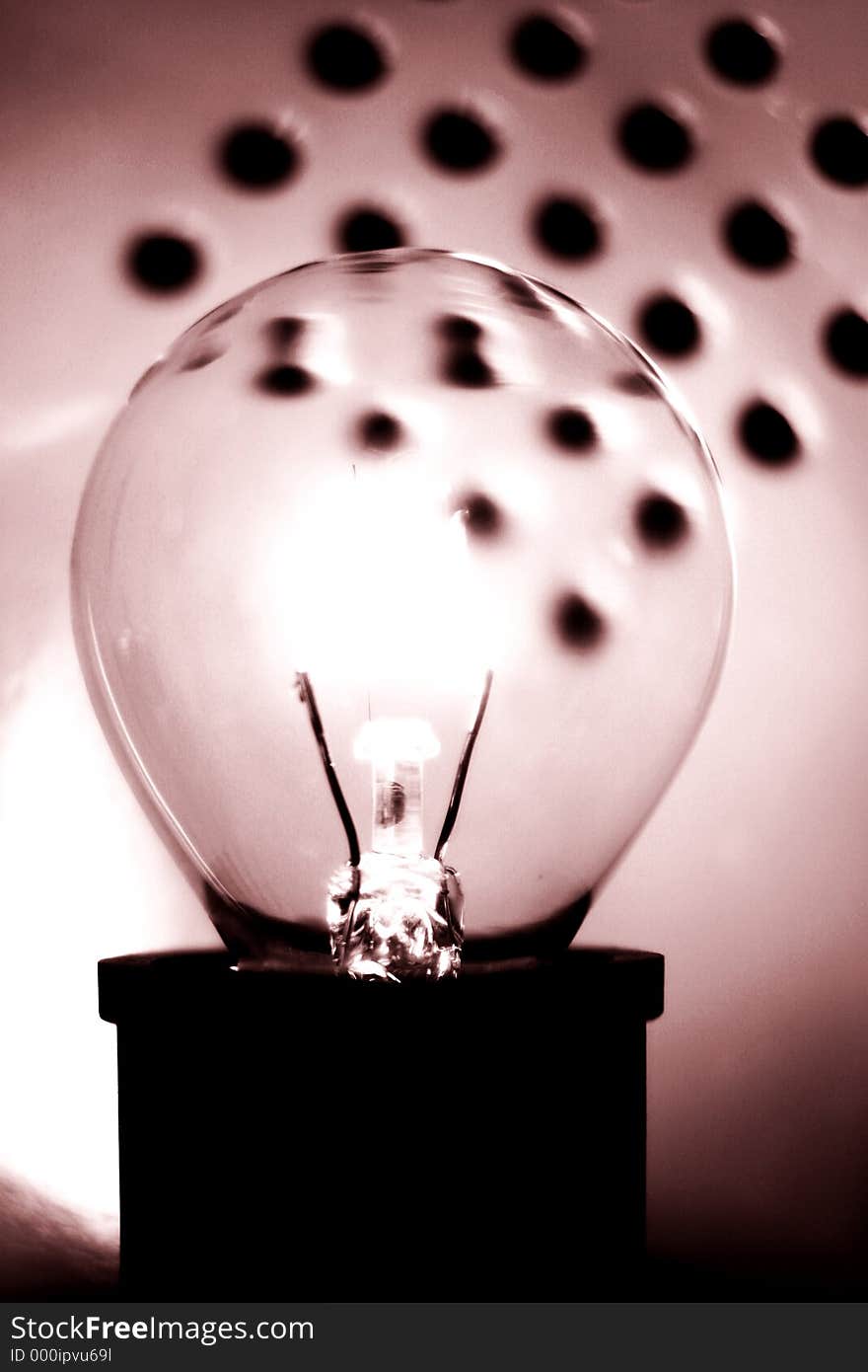 A round bulb glowing against an out of focus background. Mono sepia toned. A round bulb glowing against an out of focus background. Mono sepia toned