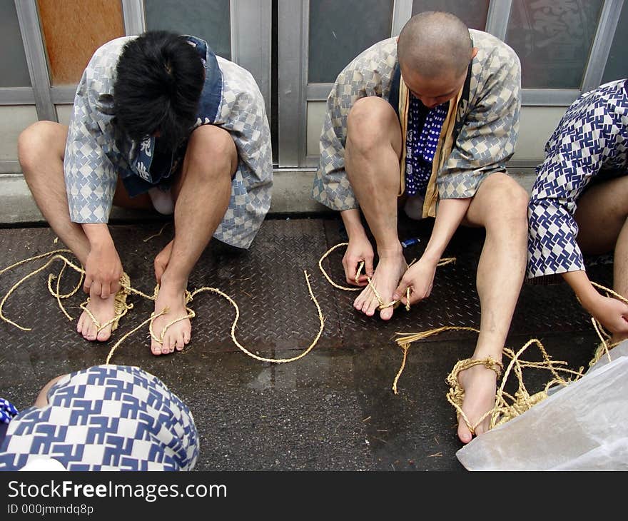 2 sumo wrestlers are getting ready for a tournament during a festival in Tokyo. 2 sumo wrestlers are getting ready for a tournament during a festival in Tokyo