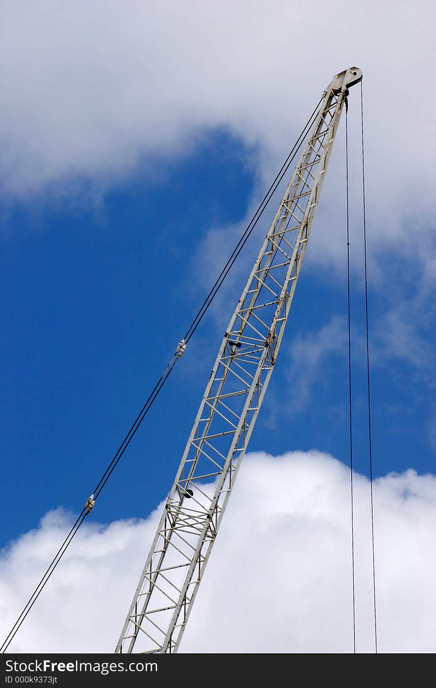 Wrecking crane on a blue sky.