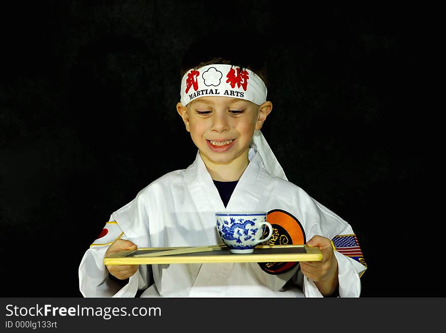 Child Wearing Karate Outfit (Gee) Holding Platter With Tea. All Logos Removed. Child Wearing Karate Outfit (Gee) Holding Platter With Tea. All Logos Removed.