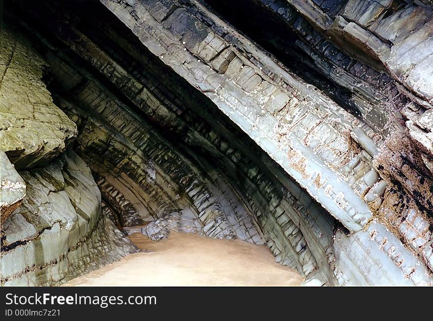 A cave in the cliffs at Newgale, Pembrokeshire, Wales, UK, clearly showing the rock formation. A cave in the cliffs at Newgale, Pembrokeshire, Wales, UK, clearly showing the rock formation