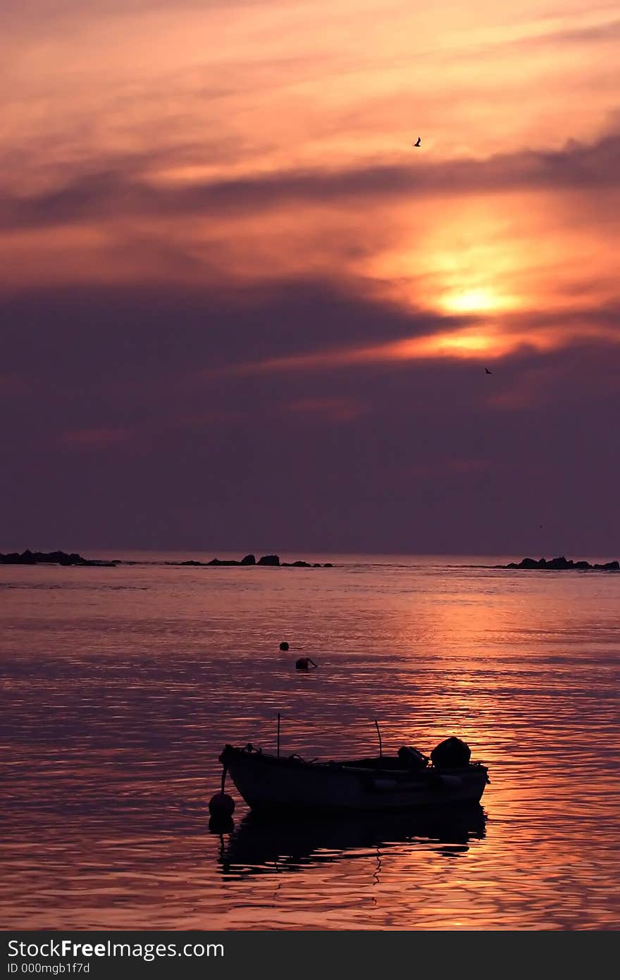 Fishing boat watching the sunset color