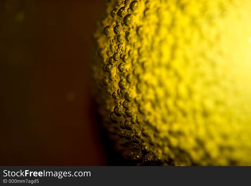 Air bubbles on the surface of an egg in yellow paint (easter theme). Shallow DOF. Air bubbles on the surface of an egg in yellow paint (easter theme). Shallow DOF.