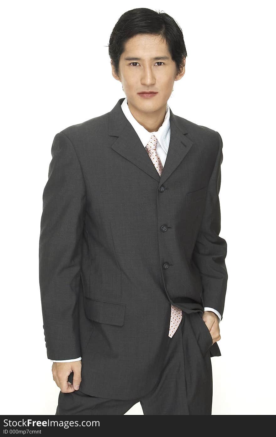 A smart asian businessman in grey suit with white shirt and pink tie. A smart asian businessman in grey suit with white shirt and pink tie