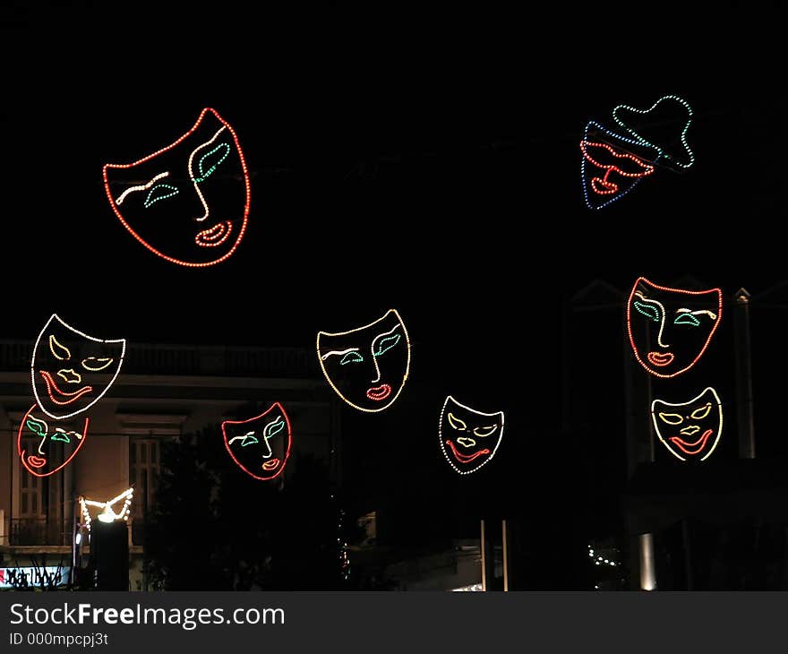 Illuminated carnival masks hunging over the street. Illuminated carnival masks hunging over the street