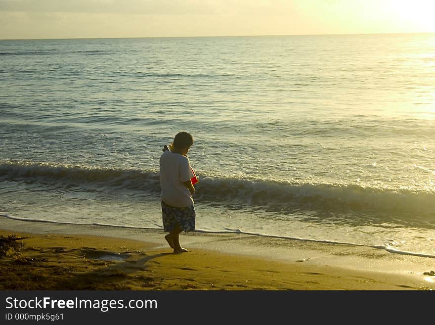 Young kid at the beach eary in the morning. Young kid at the beach eary in the morning