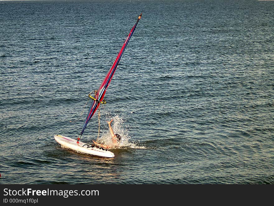 Man falling of his surfboard. Man falling of his surfboard